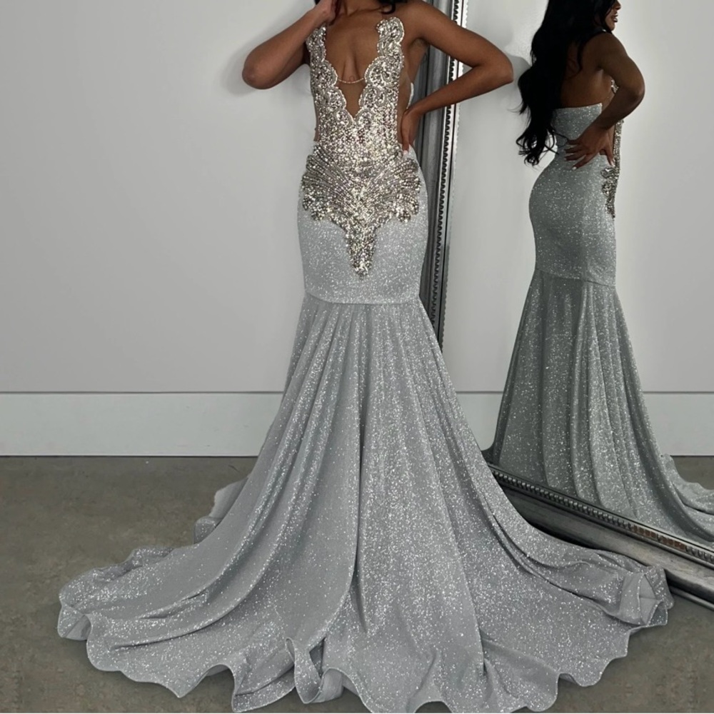 This prom dress is from Alglist. The color is silver and has sparkles.
